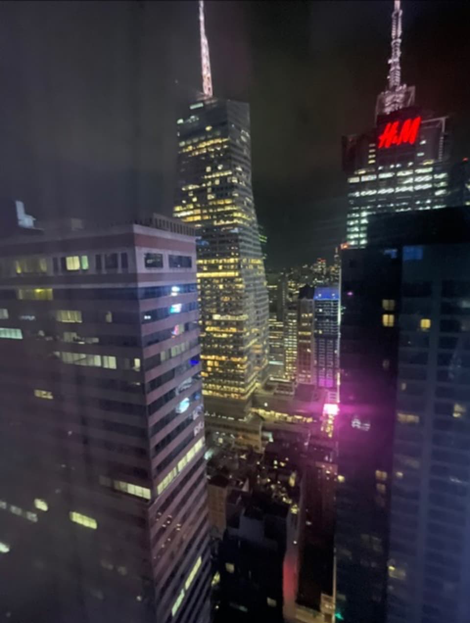 Hyatt Centric Times Square New York suite living area with modern furnishings and city views