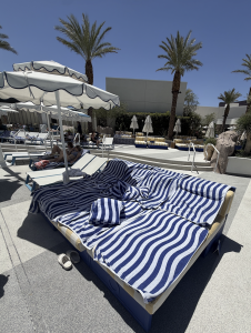 Oasis day bed with striped cushions and umbrella at the Fontainebleau Las Vegas pool
