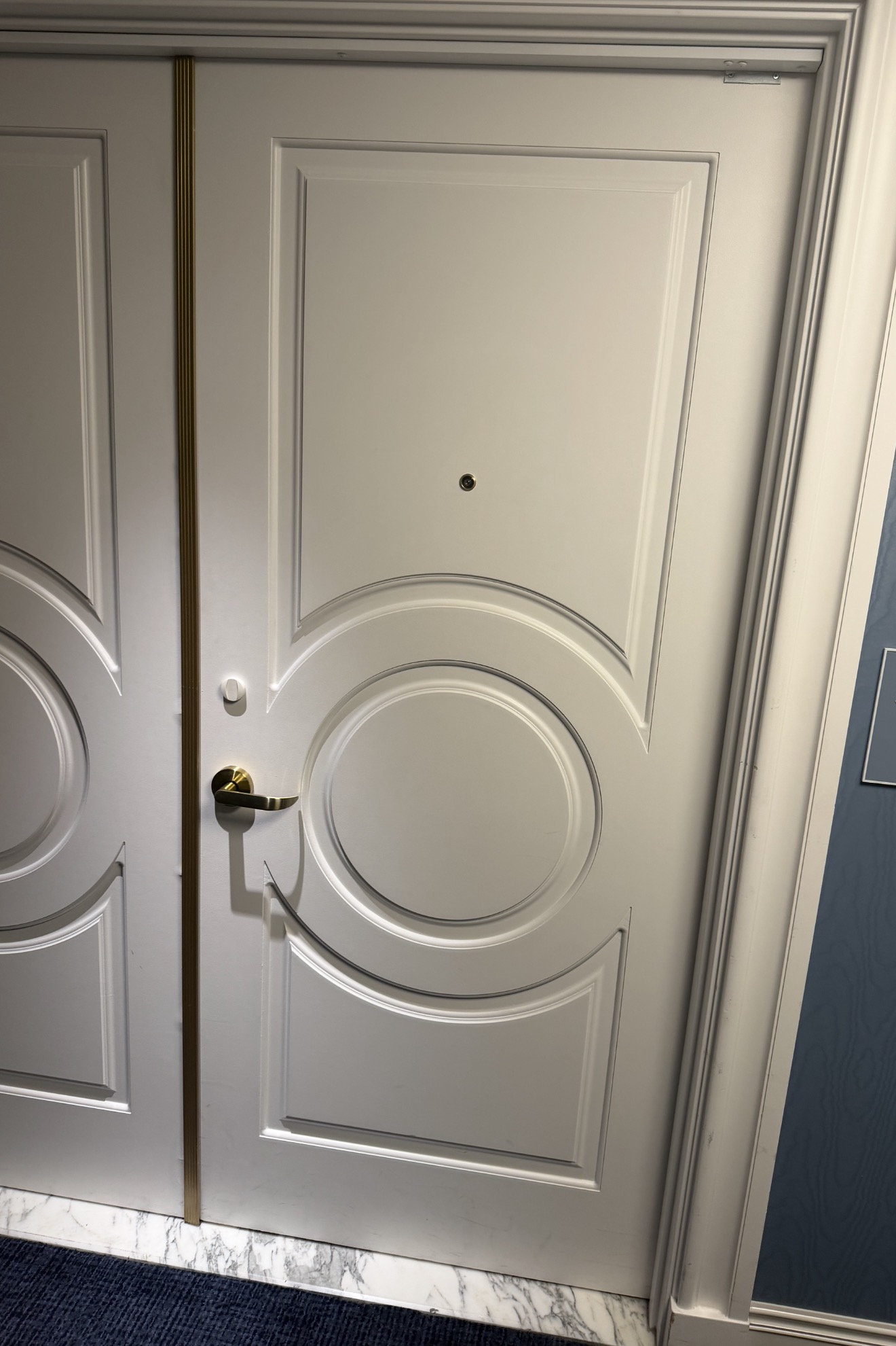 Suite entry door with gold lever handle at Fontainebleau Las Vegas