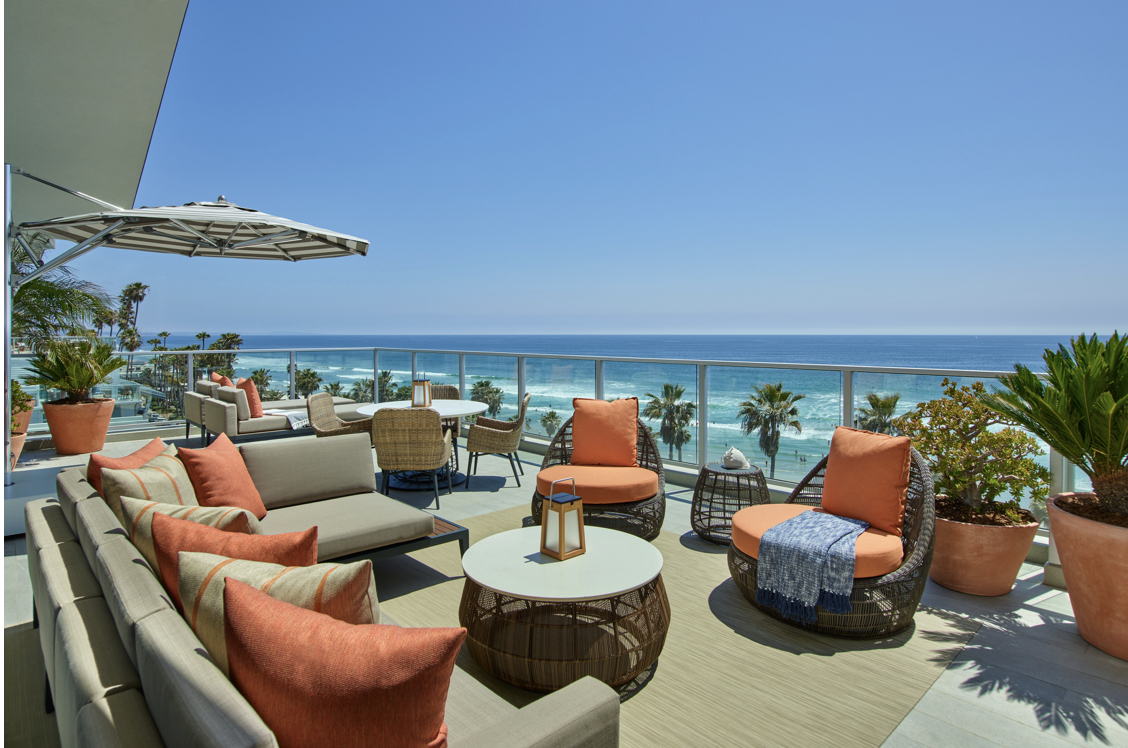 Oceanfront balcony of the Estate Suite at The Seabird in Oceanside with lounge seating and Pacific views